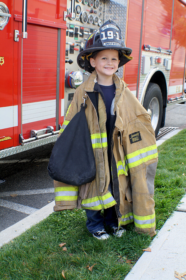 Boy dressed in real life firefighter garb